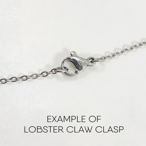 A close-up of a silver chain with a lobster claw clasp centered on a white background. Below the chain, "EXAMPLE OF LOBSTER CLAW CLASP" is written, demonstrating the clasp style used for the Boho Meditation Heart Necklace. Read more at Stamping Cat Studio (stampingcatstudio.com).