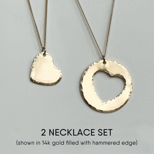 The Mother Daughter Heart Necklace Set features two 14k gold-filled necklaces: one with a solid heart pendant, the other with a round pendant and heart cutout, both on fine chains—a meaningful gift for moms and daughters. Read more at Stamping Cat Studio (stampingcatstudio.com).