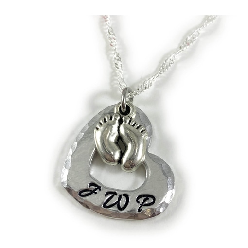 The Baby Feet and Heart Necklace features a hammered silver heart pendant with a central baby feet charm and "JWP" engraved in black at the bottom, all hanging from a delicate chain. Read more at Stamping Cat Studio (stampingcatstudio.com).